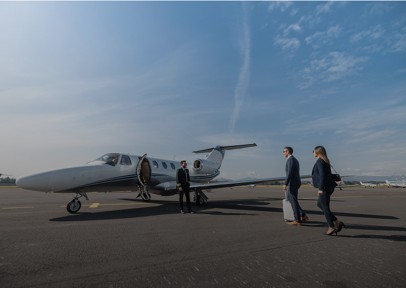 People boarding a private jet on tarmac.