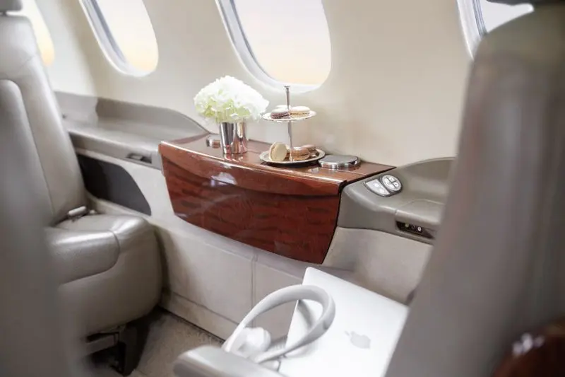 Luxurious airplane interior with wood paneling and elegant decor.