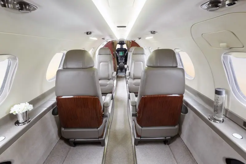 Interior view of a private jet cabin with leather seats.