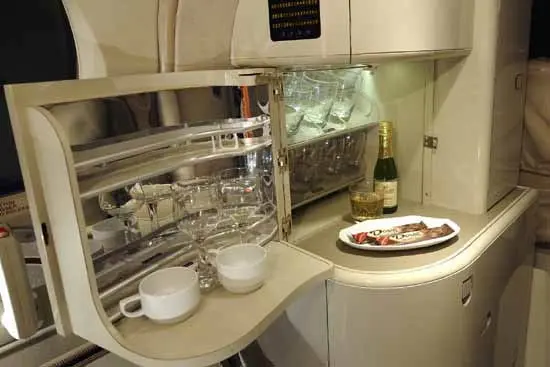 Luxurious private jet bathroom with elegant fixtures and champagne.