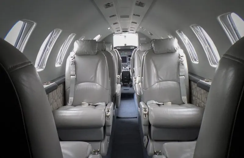 Luxurious leather seats inside a private jet cabin.