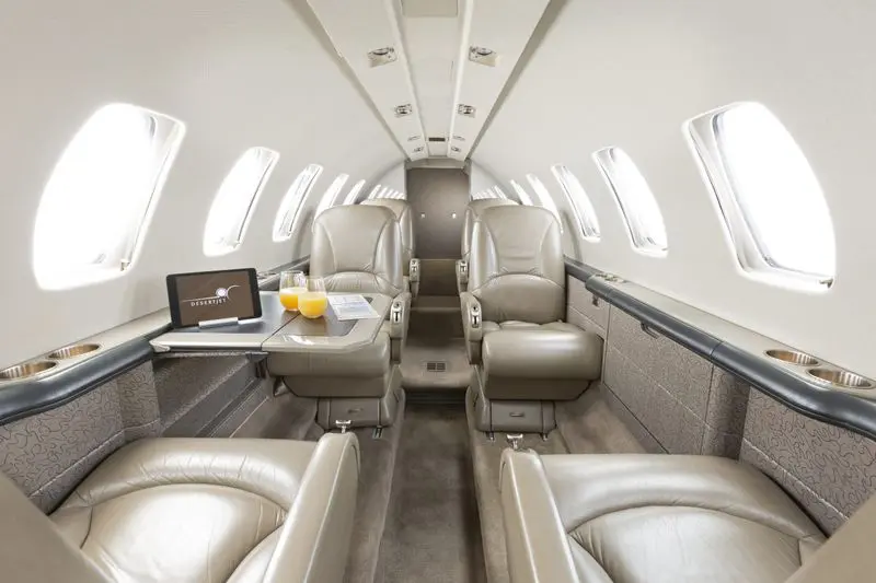 Luxurious private jet interior with plush leather seats and elegant design.