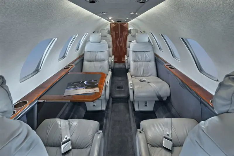Luxurious interior of a private jet with comfortable leather seats.