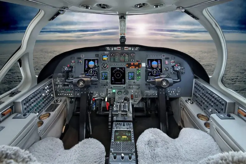 Inside view of an airplane cockpit with controls and instruments.
