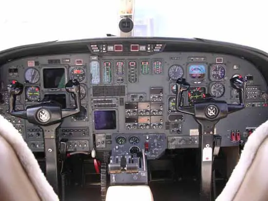Cockpit of a commercial airplane with various flight instruments and controls.