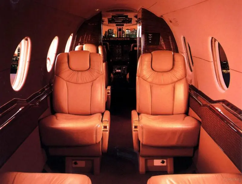 Luxurious leather seats inside a private jet cabin.