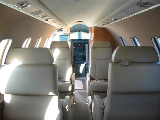 Luxurious interior of a private jet with leather seats and modern design.