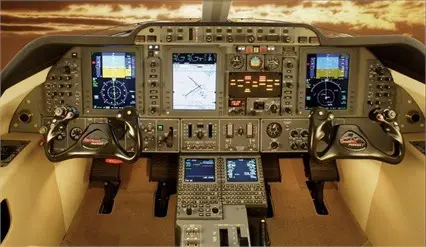 Cockpit view of a modern aircraft with advanced avionics displays.