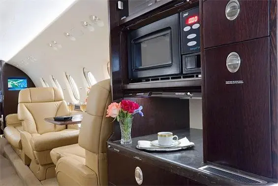 Luxurious private jet interior with elegant seating and refreshments.