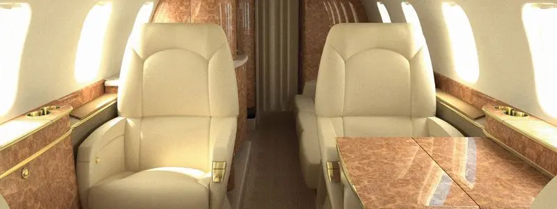 Luxurious beige leather seats in a spacious private jet cabin.