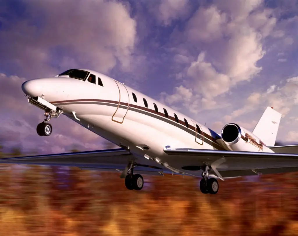A private jet preparing for takeoff with a dramatic sky.