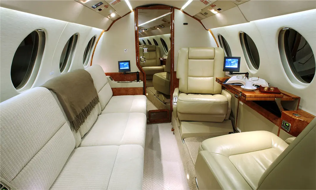 Luxurious private jet interior with plush seating and modern amenities.