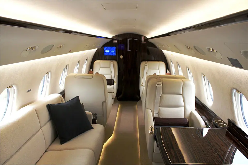 Luxurious private jet interior with plush seating and ambient lighting.