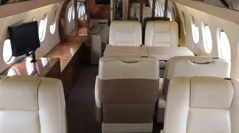Luxurious interior of a small private jet with leather seats.
