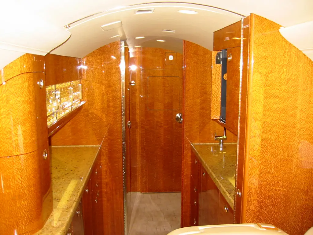 Interior view of a wooden cabin bathroom with warm lighting.