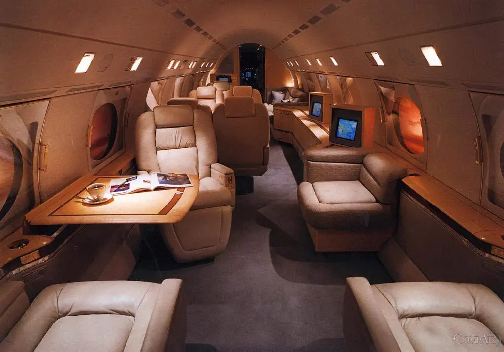 Luxurious private jet cabin with plush seating and elegant lighting.