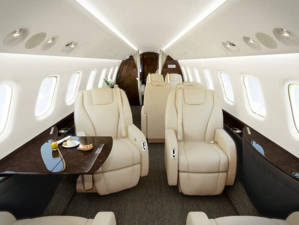 Luxurious leather seats inside a private jet cabin.