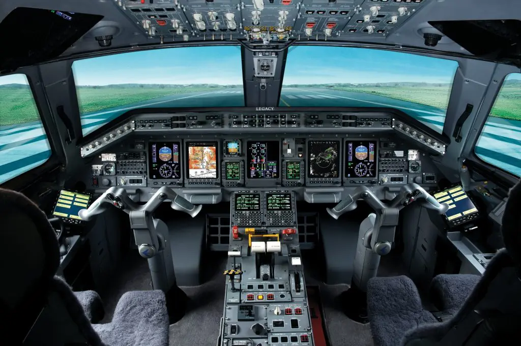Cockpit of a modern commercial airplane with advanced flight controls and displays.