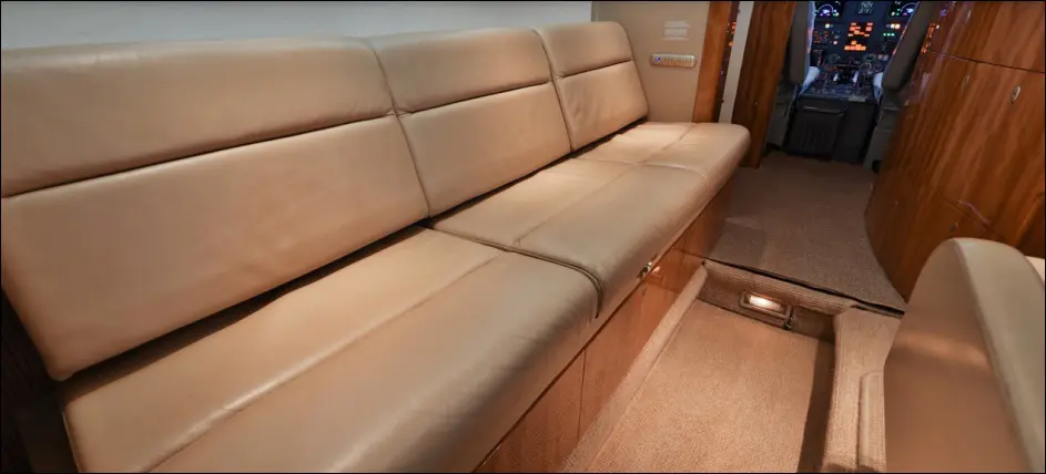 A beige leather sofa with clean lines in a cozy room.