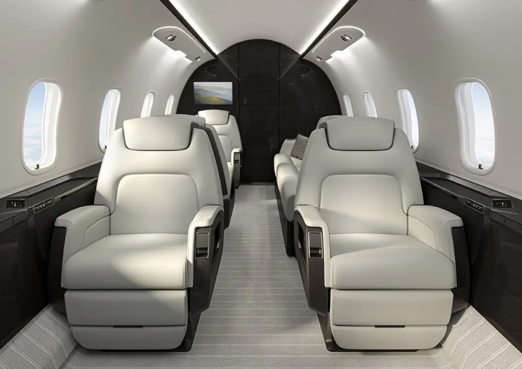 Luxurious private jet interior with spacious leather seats.