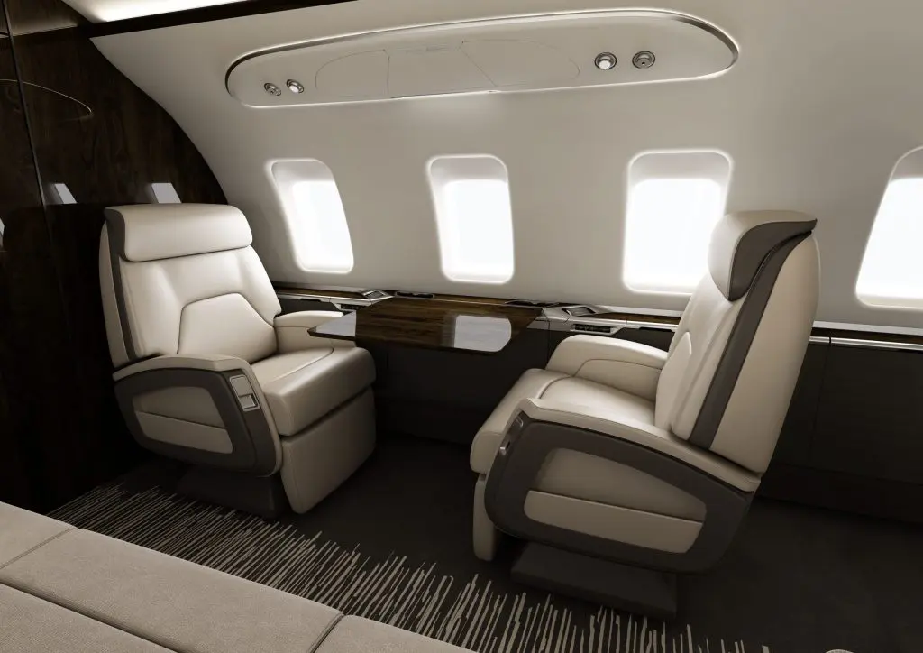 Luxurious private jet interior with spacious leather seats and ambient lighting.
