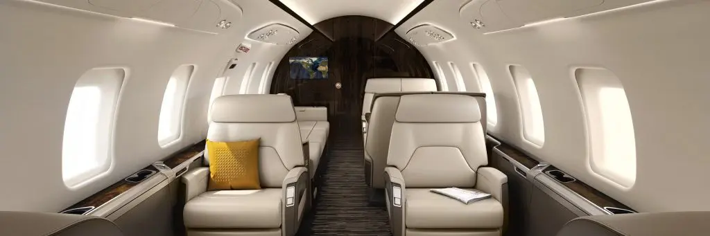 Luxurious beige leather seats inside a private jet cabin.