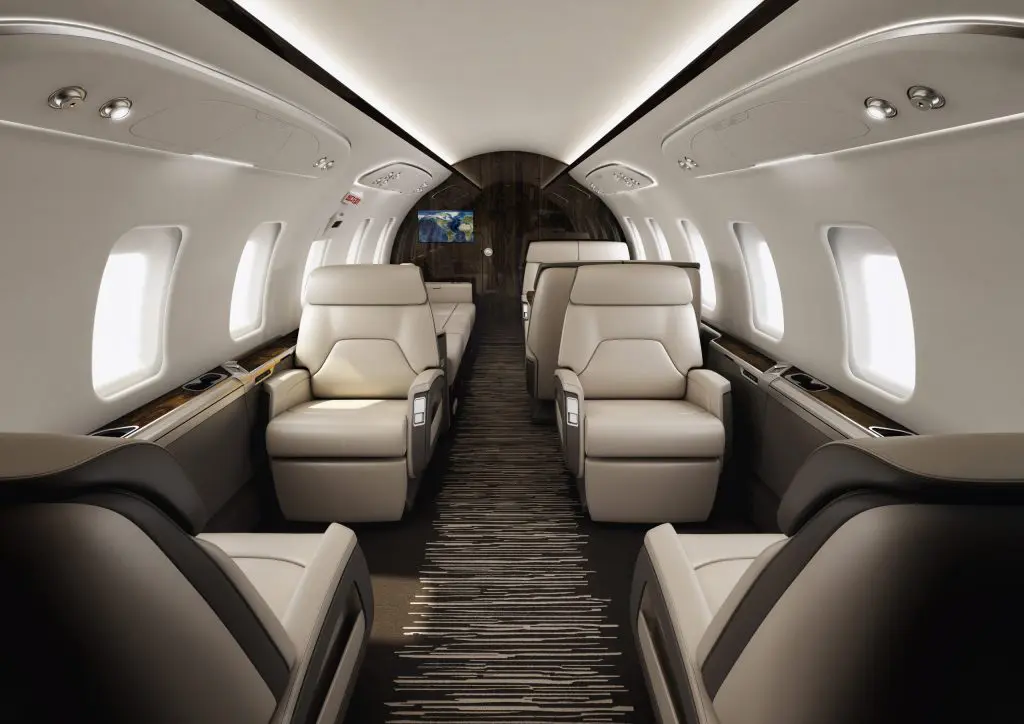 Luxurious private jet interior with plush leather seats and ambient lighting.