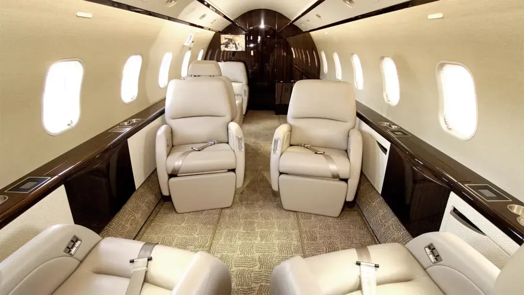 Luxurious private jet interior with plush leather seats.
