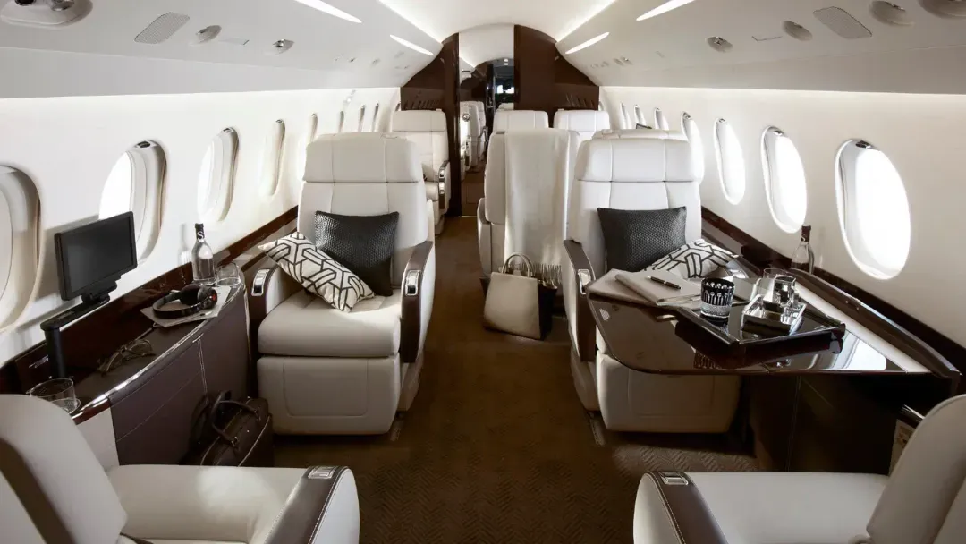 Luxurious private jet interior with spacious leather seats and elegant accents.