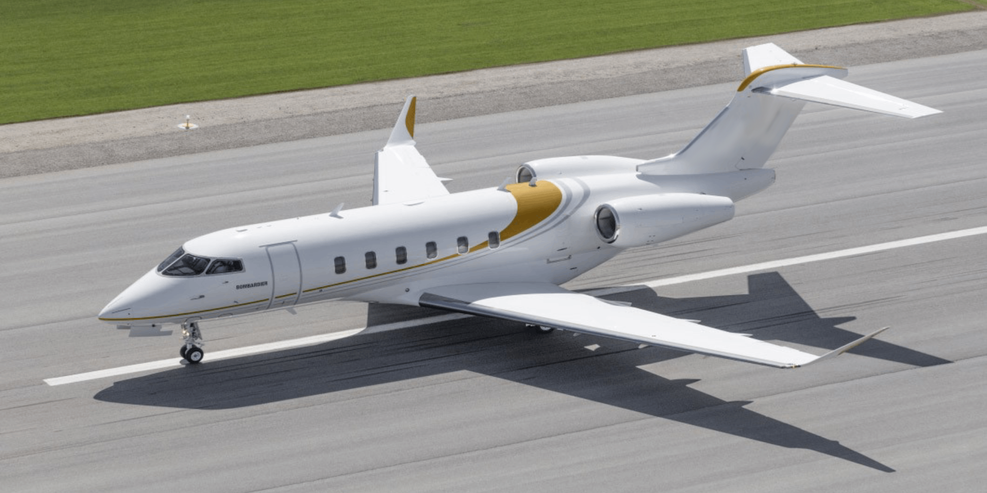 Private jet taxiing on runway with sleek design.