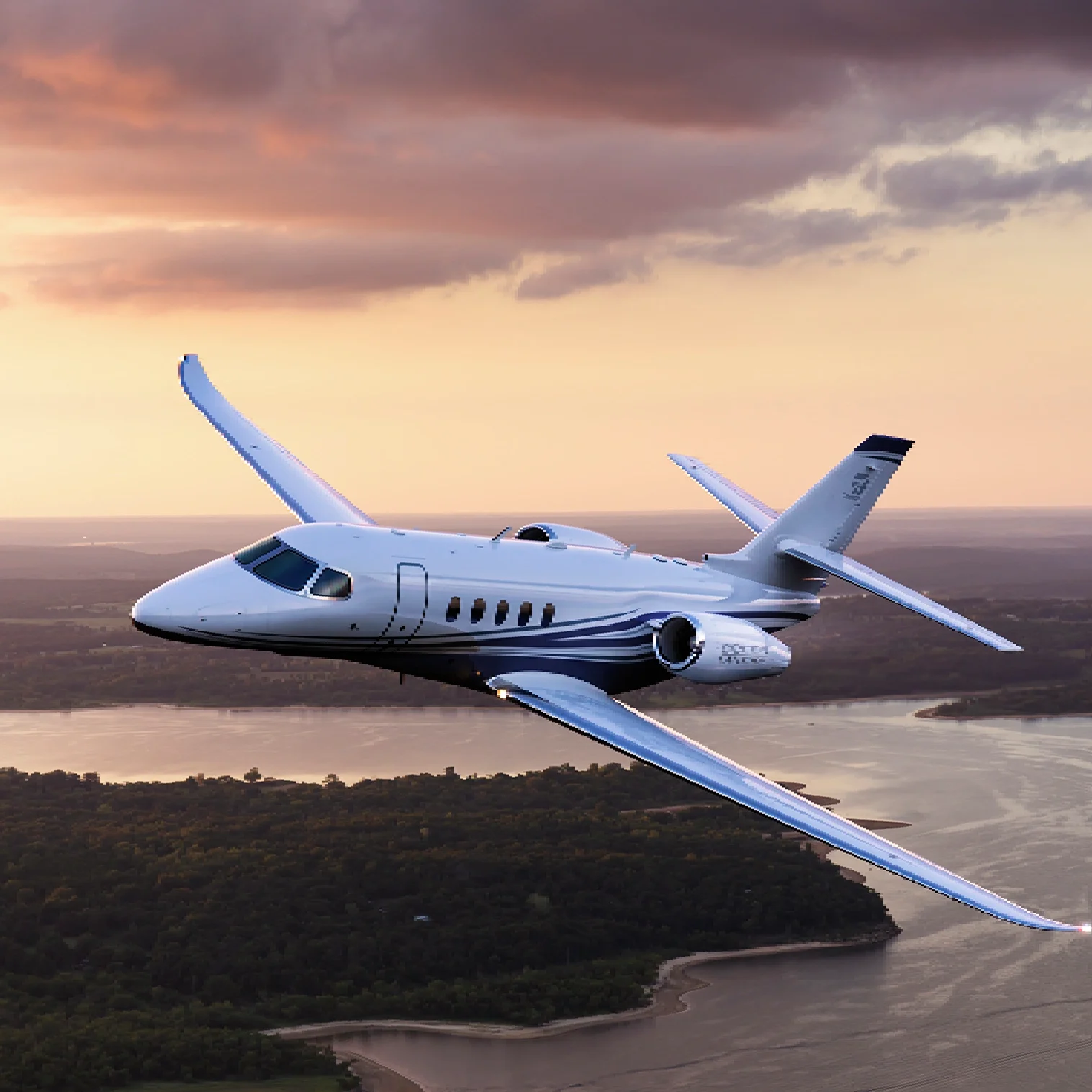 A private jet flying over a coastal landscape at sunset.