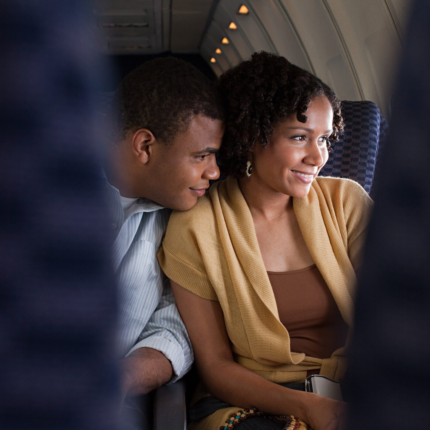 Couple sitting together on an airplane.